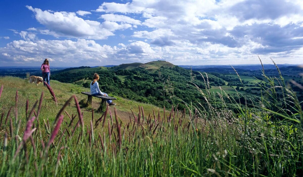 Girl sitting on a bench on the Malvern Hills