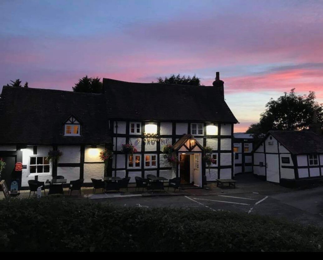 The Rose and Crown is a typical black and white Tudor building here pictured lit at night