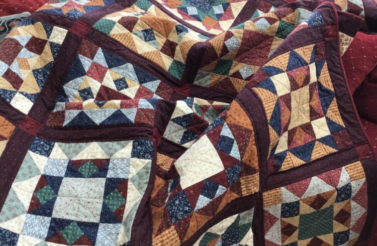 Multi-coloured quilt with geometric shapes