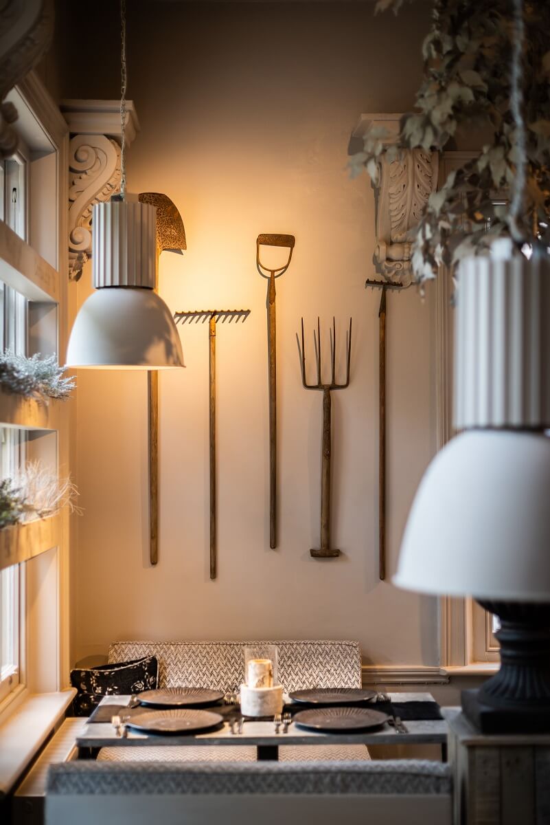 Dining area with agricultural implements as wall decorations