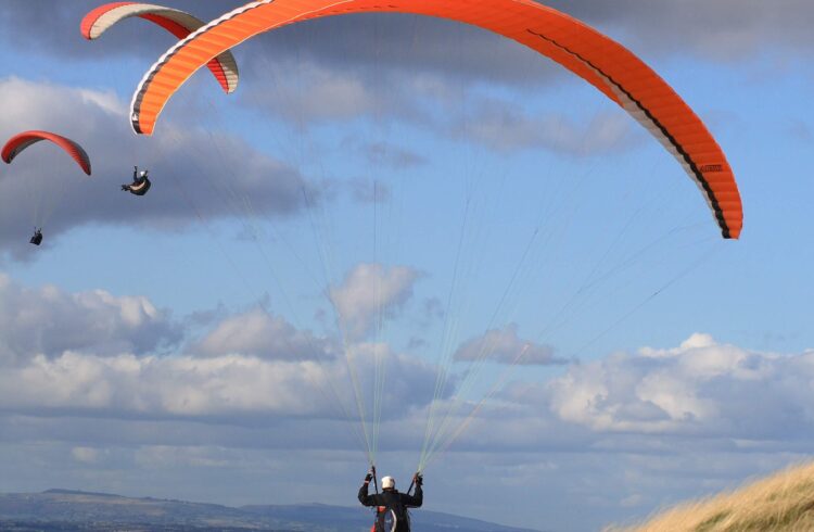 three paragliders off the Malvern Hills