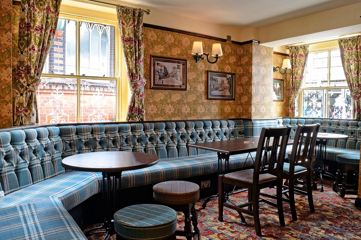Pub interior - tables and chairs, old photos on the walls