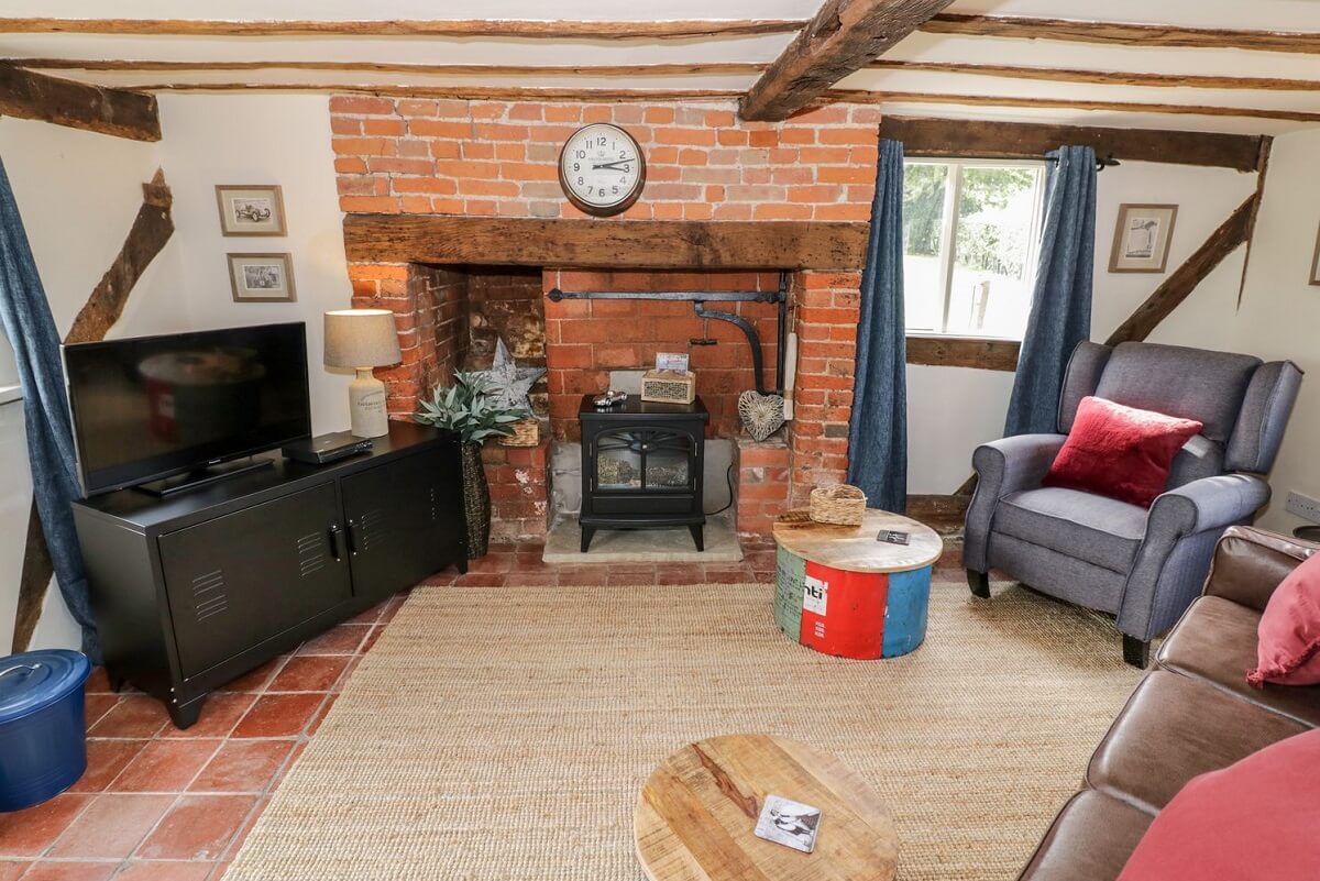 Sitting room with sofa, chair, TV, fire