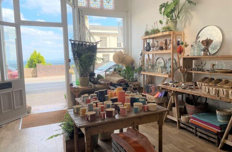 Bright shop interior with wooden floors selling ceramics and homeware