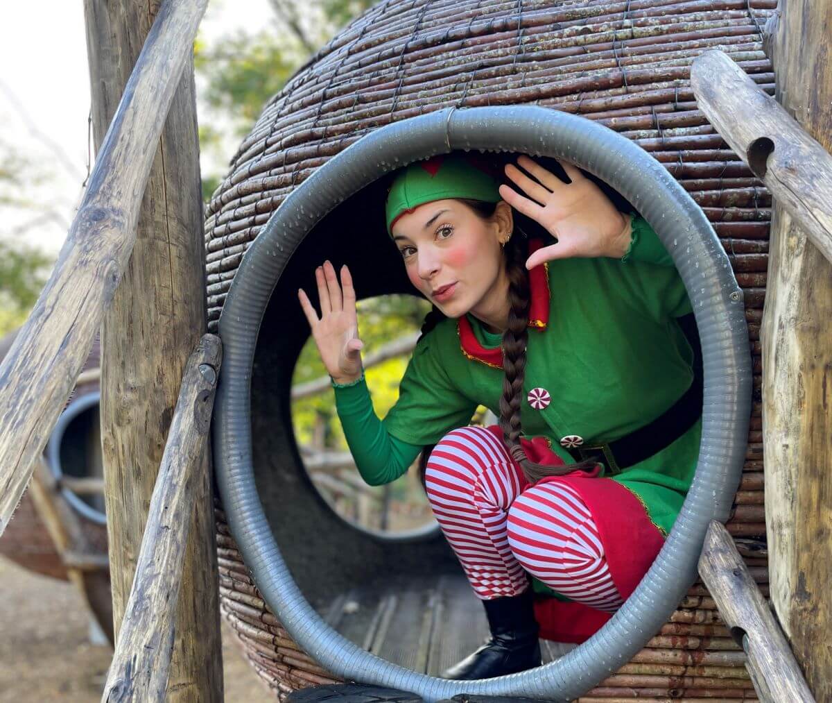 A Christmas elf playing in a playground