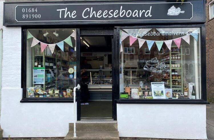 Exterior of a cheese shop with bunting in the window