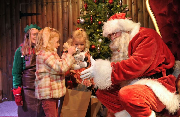 Santa presenting children gifts at Winter Glow