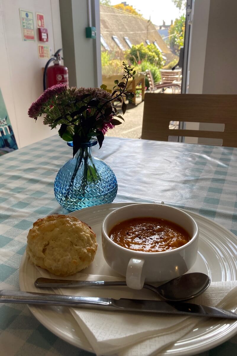 A bowl of soup and a scone at Book and Cup Cafe