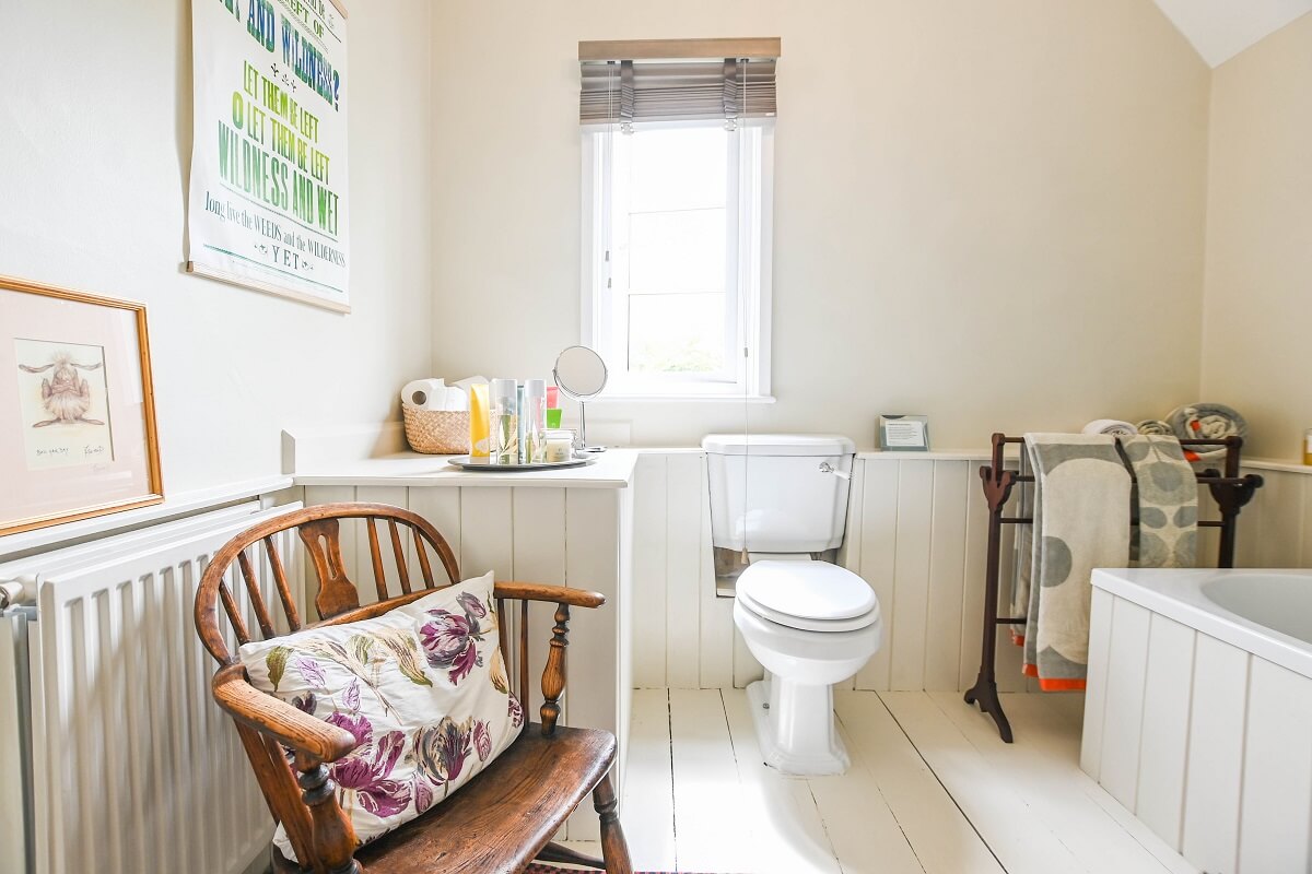 Bathroom with towels, toiletries and chair