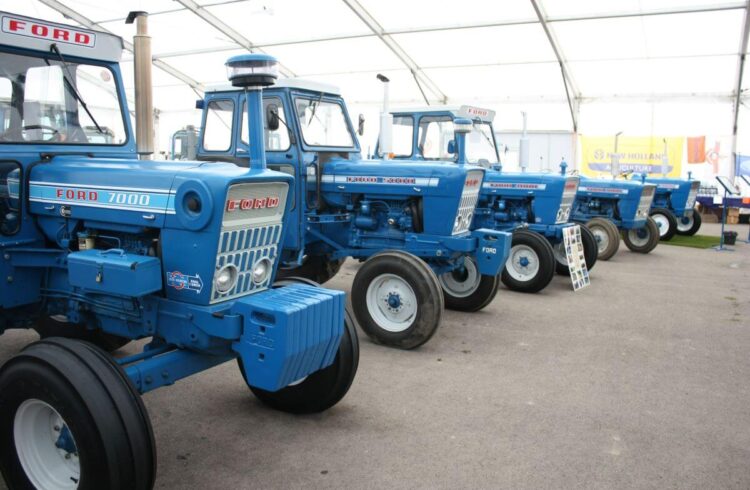 A row of blue tractors