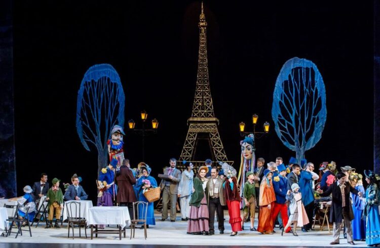 The cast of La boheme with the Eiffel tower.