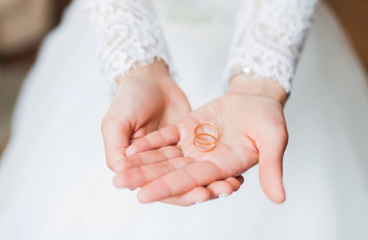 A bride holding two wedding rings