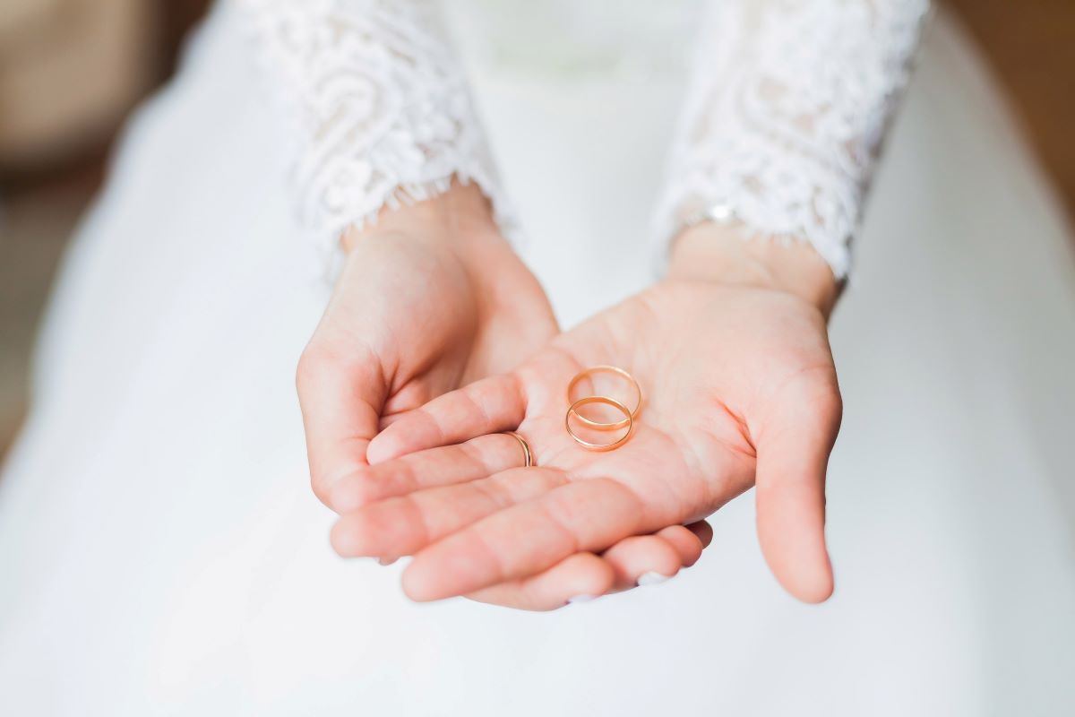 A bride holding two wedding rings