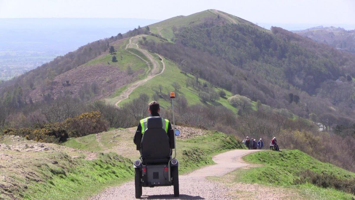 A person riding a mobility scooter on the malvern hills