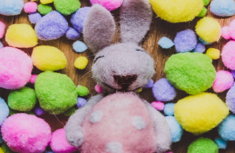 A felt Easter bunny surrounded by felt Easter eggs