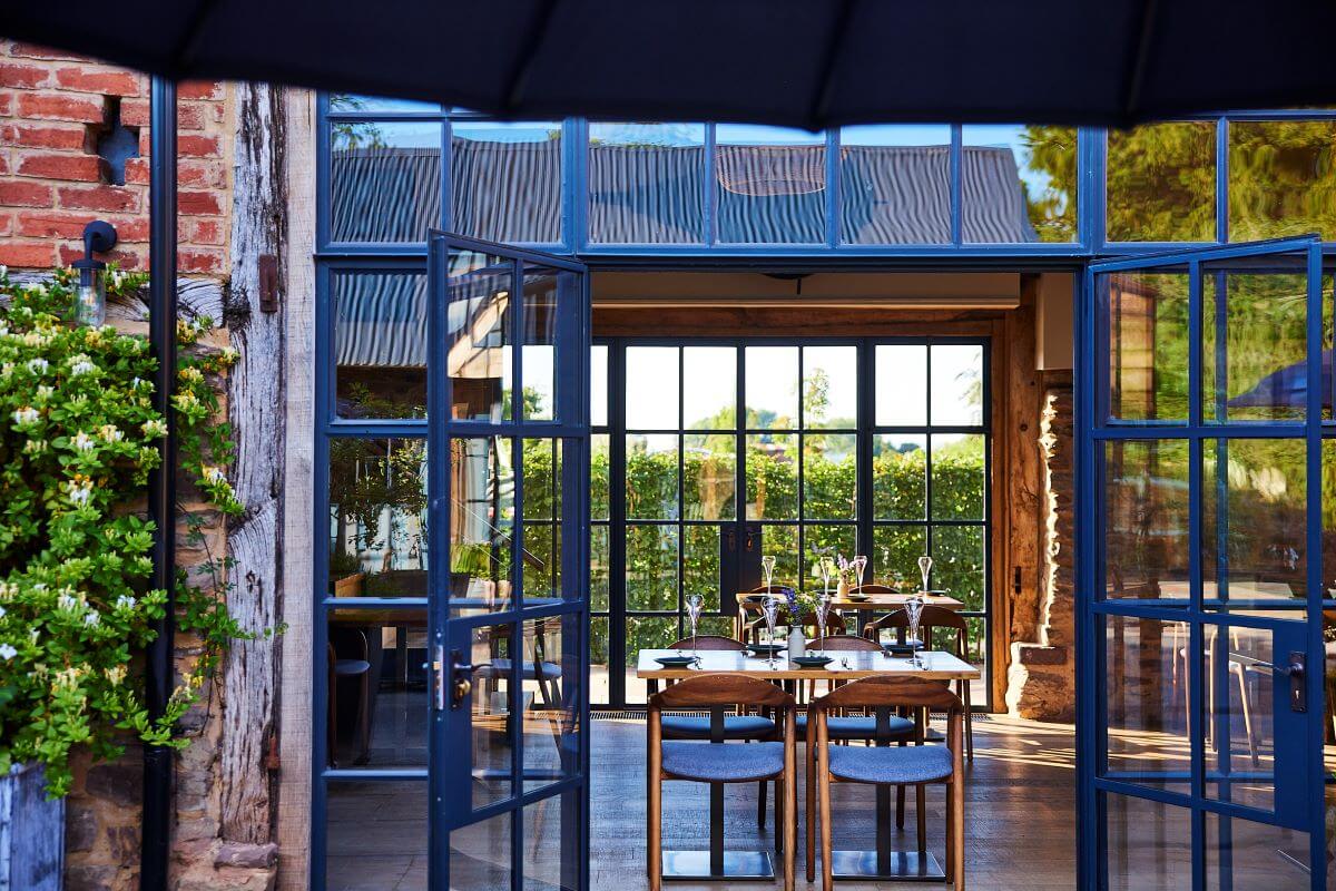 Barn style restaurant with open Crittall windows
