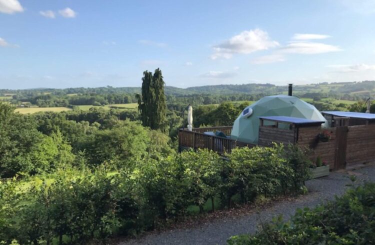 Transparent dome house in green countryside