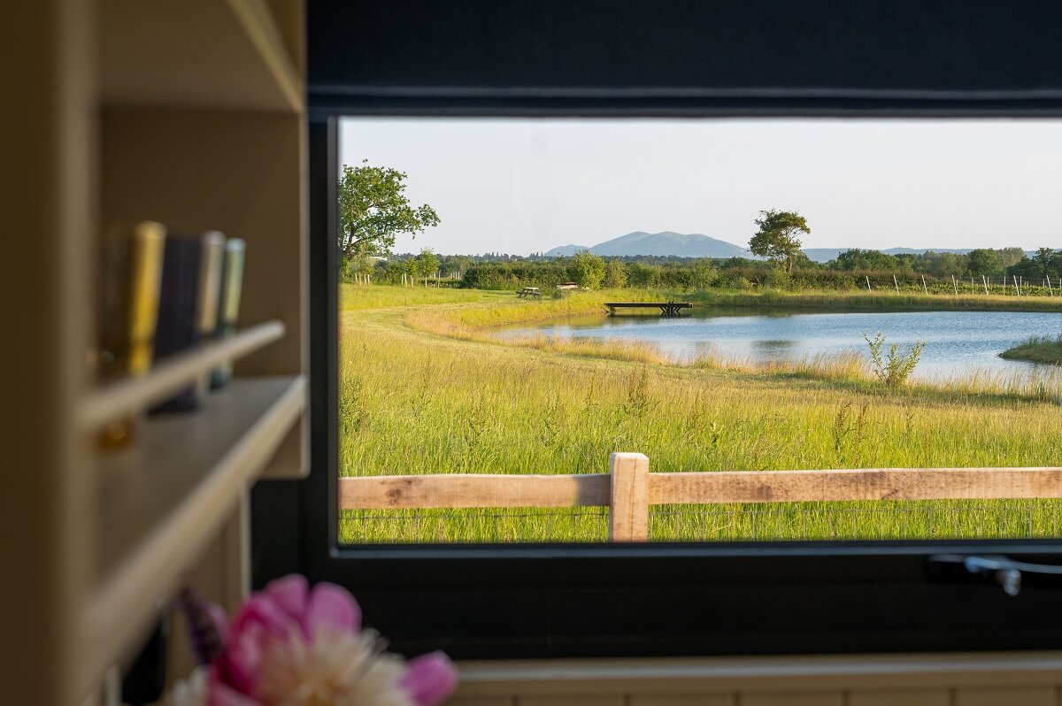 View from shepherd hut over pool to Malvern Hills in the distance