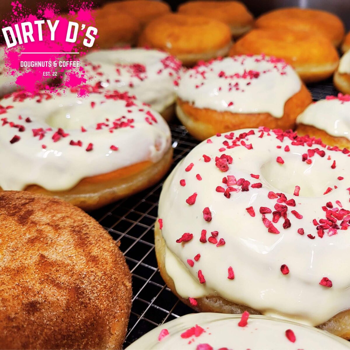 Doughnuts with white icing and pink sprinkles
