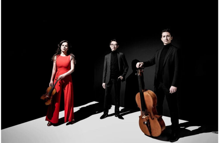 Members of the Amatis Piano Trio dressed in black or red
