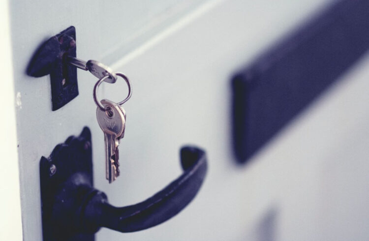 Stock image of a key in a door