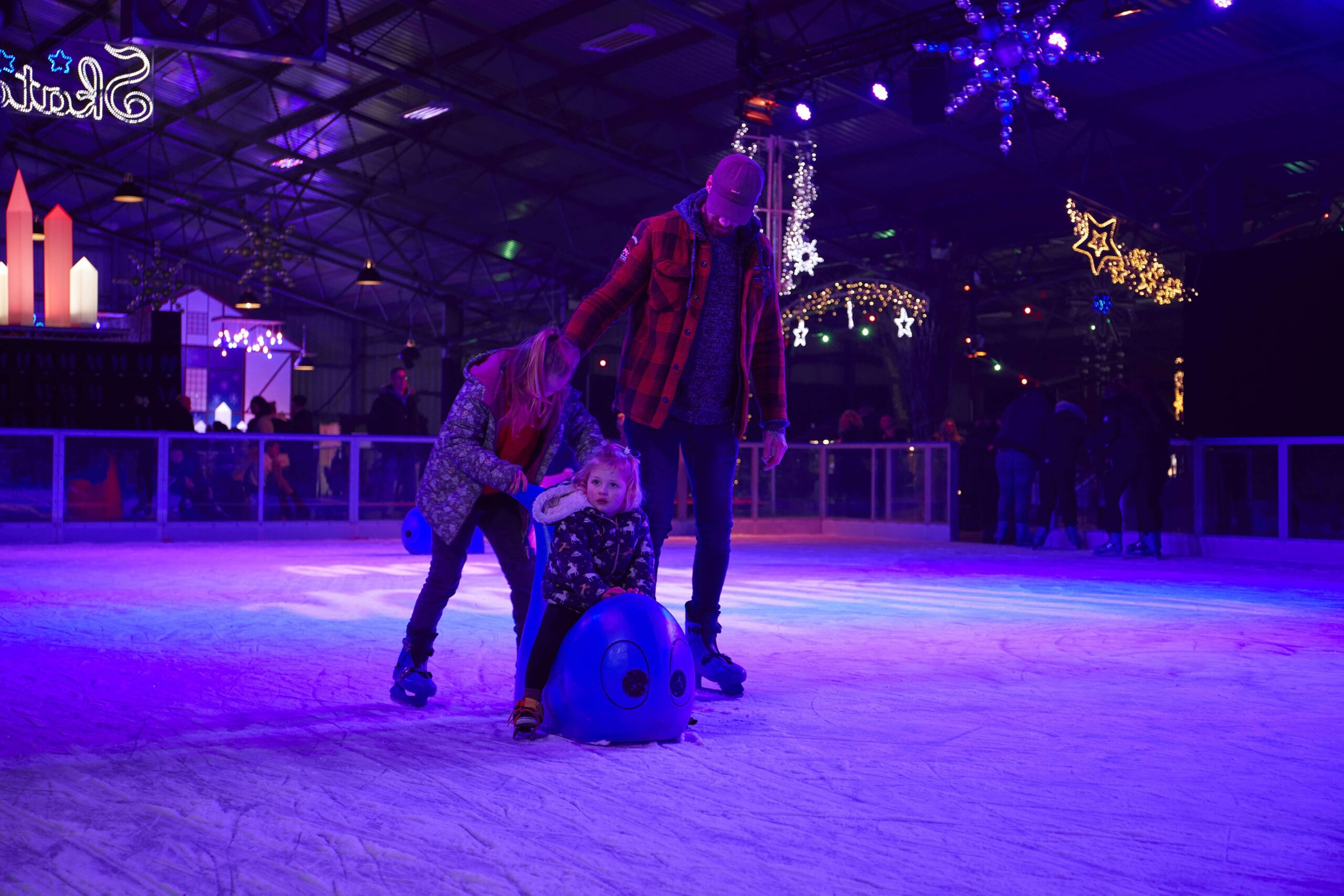 an adult and child ice skating