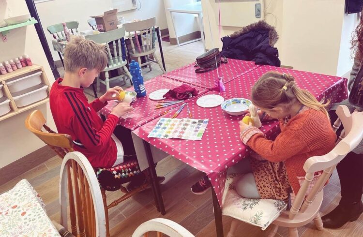 2 Children painting pottery
