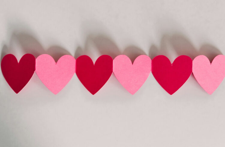 A row of pink and red paper hearts