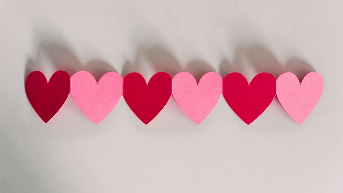 A row of pink and red paper hearts