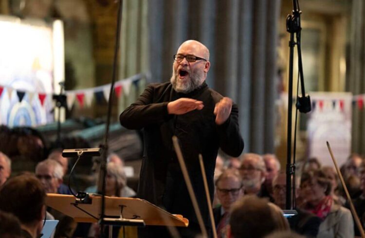 a composer leading an orchestra in a church