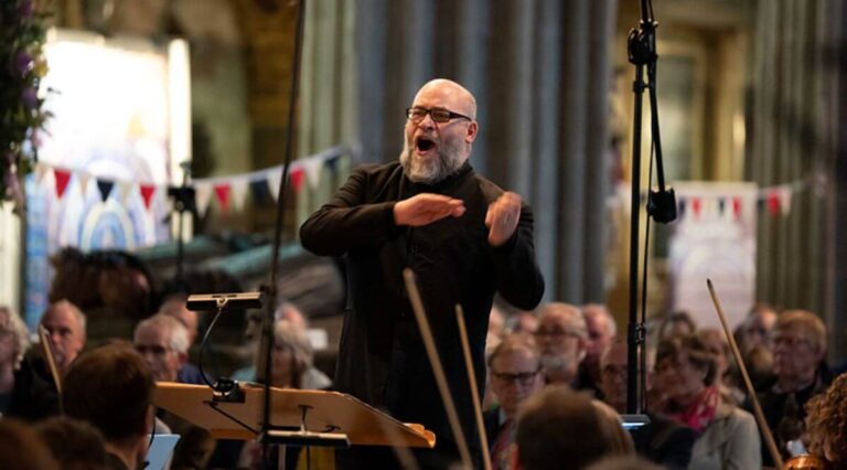 a composer leading an orchestra in a church