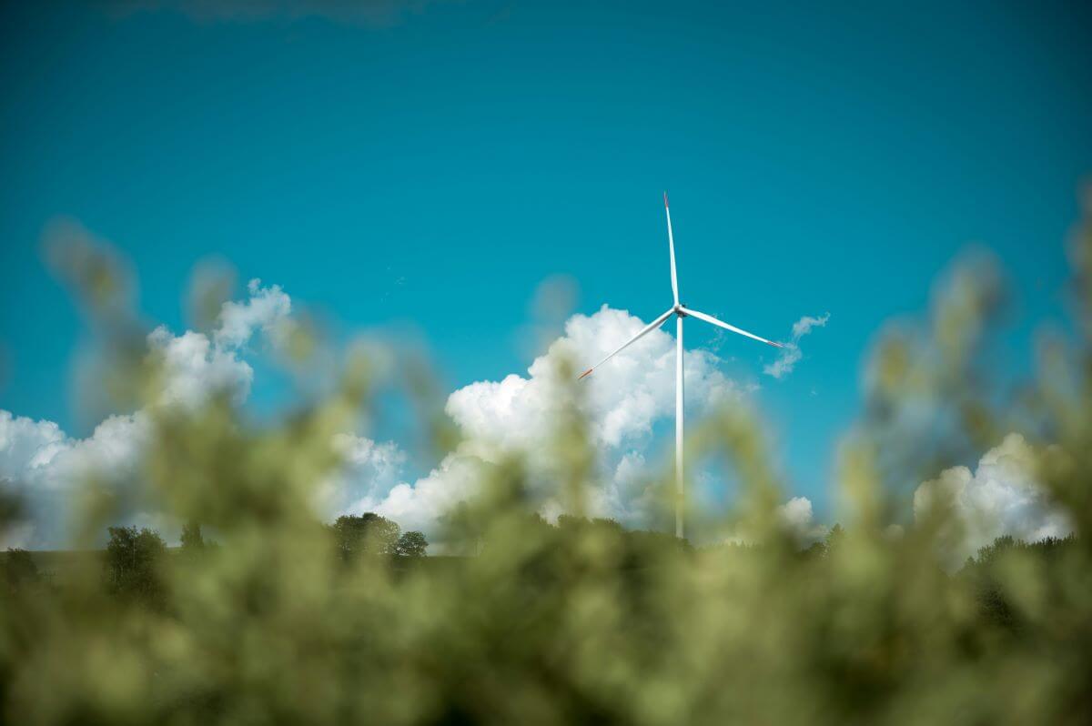 A wind turbine against blue sky