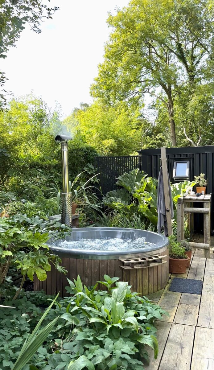 An outdoor hot tub surrounded by greenery