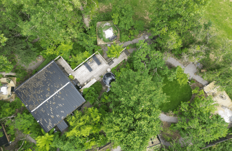 An aerial view of a cabin in the woods