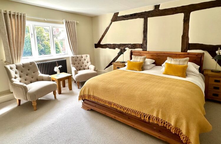 A bedroom decorated in shades of cream, yellow and gold