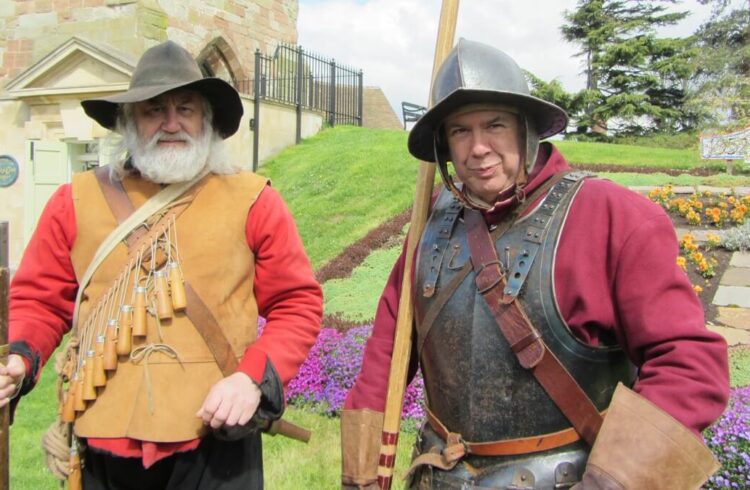 Two re-enactors dressed in period-appropriate costume standing outside the 'Pepperpot' tower in Upton upon Severn