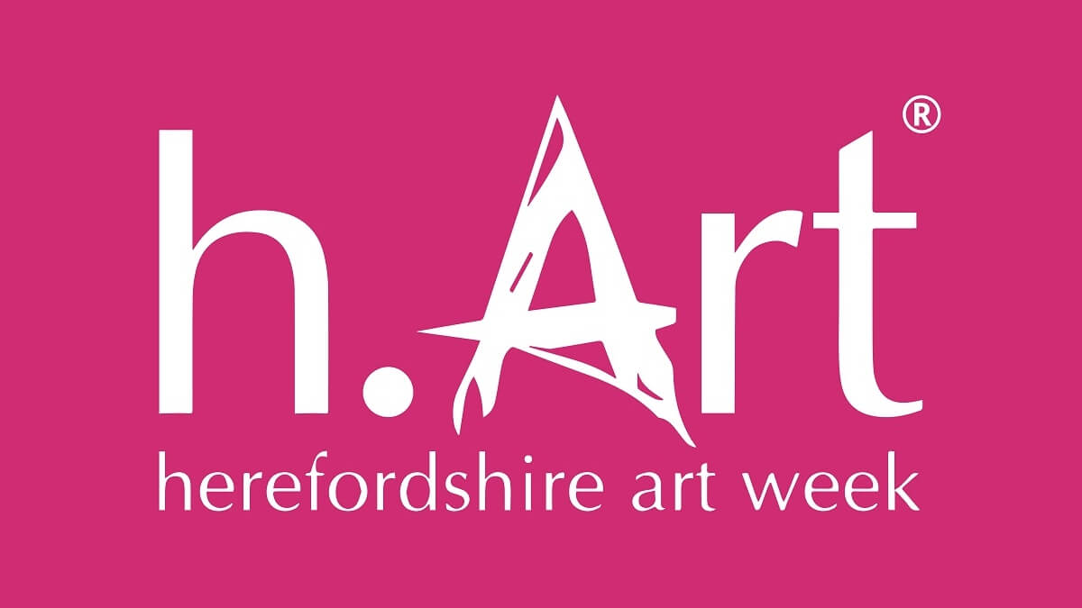 The logo for Herefordshire Art Week in white on a pink background