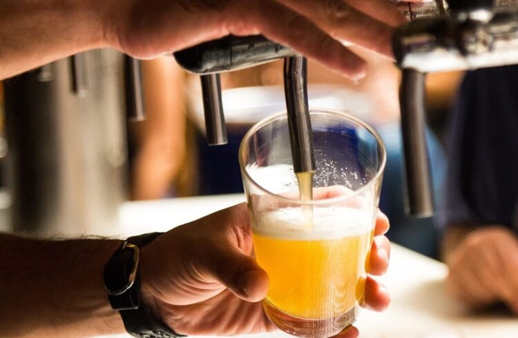 A pint of beer being served in a pub