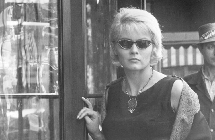 A still from the film showing a woman in dark glasses