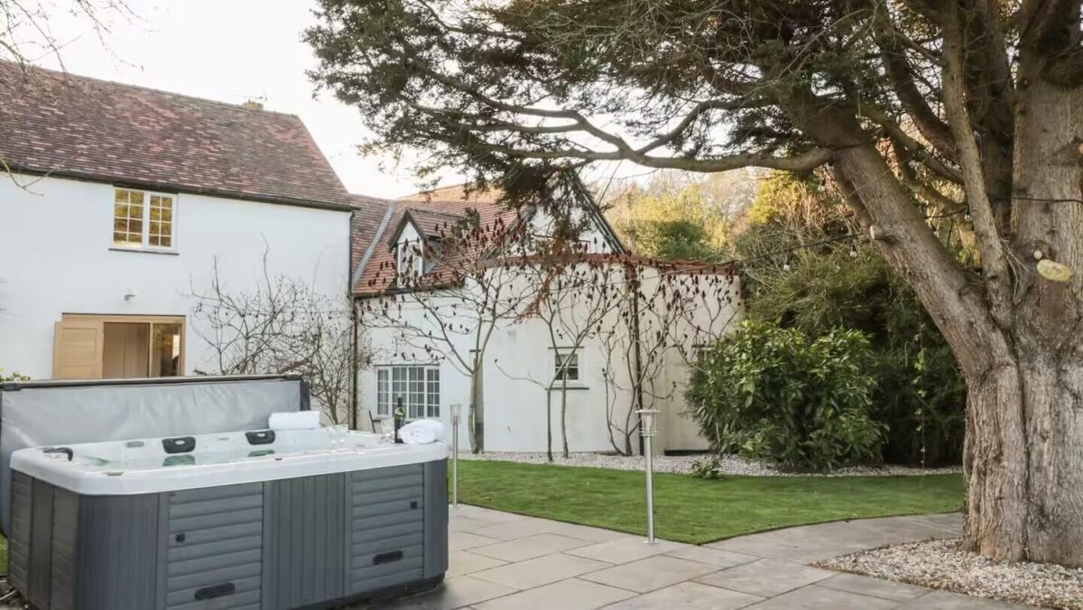 Exterior of the house with mature tree and hot-tub