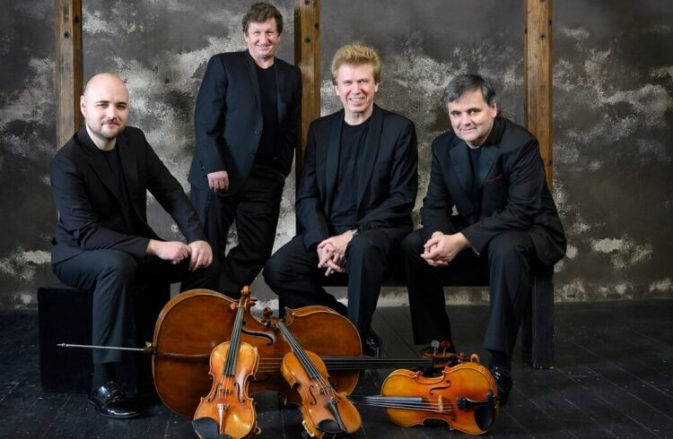 Four musicians, all dressed in black