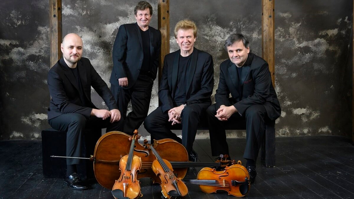 Four musicians, all dressed in black